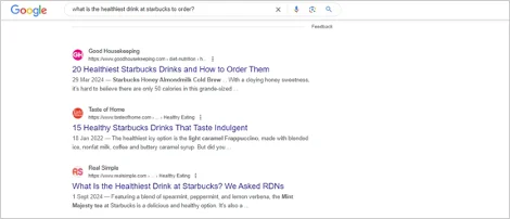 Screenshot of Google search results for "what is the healthiest drink at Starbucks to order?" showing top-ranking articles.